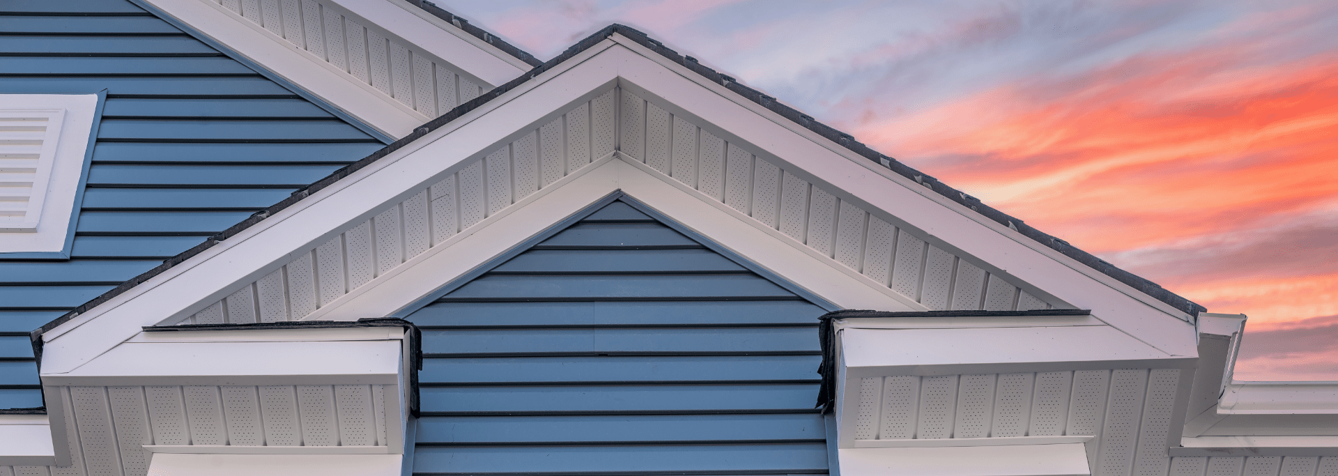 blue siding house with sunset background