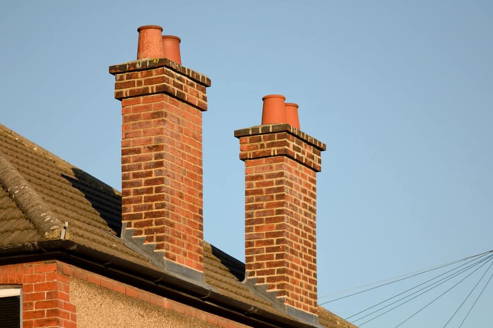 two chimneys on large house roof