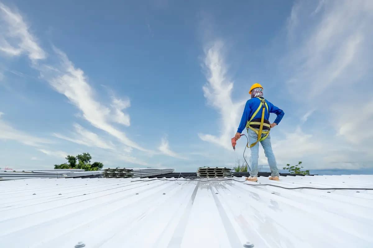 roofer on metal roof