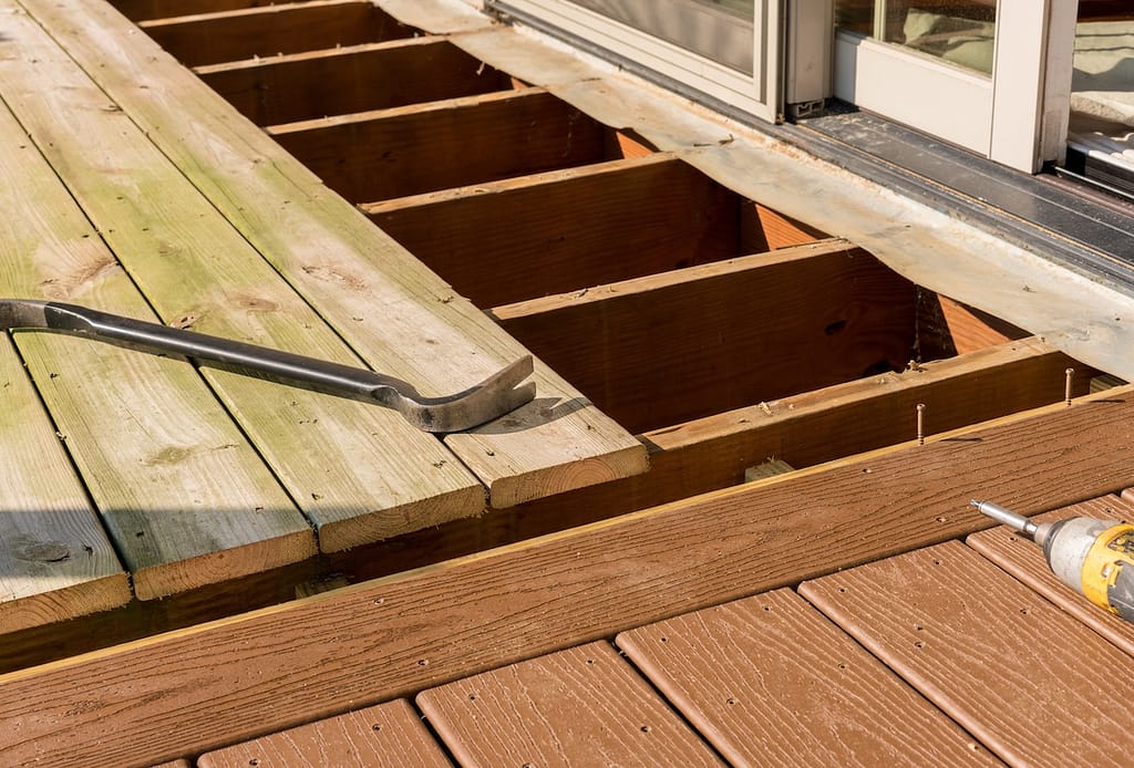 Repair and replacement of an old wooden deck or patio with modern composite plastic material