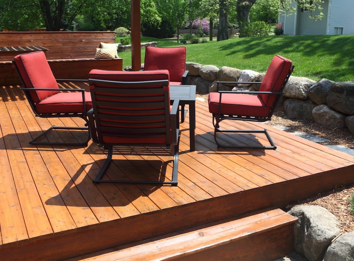 a patio with chairs and a table