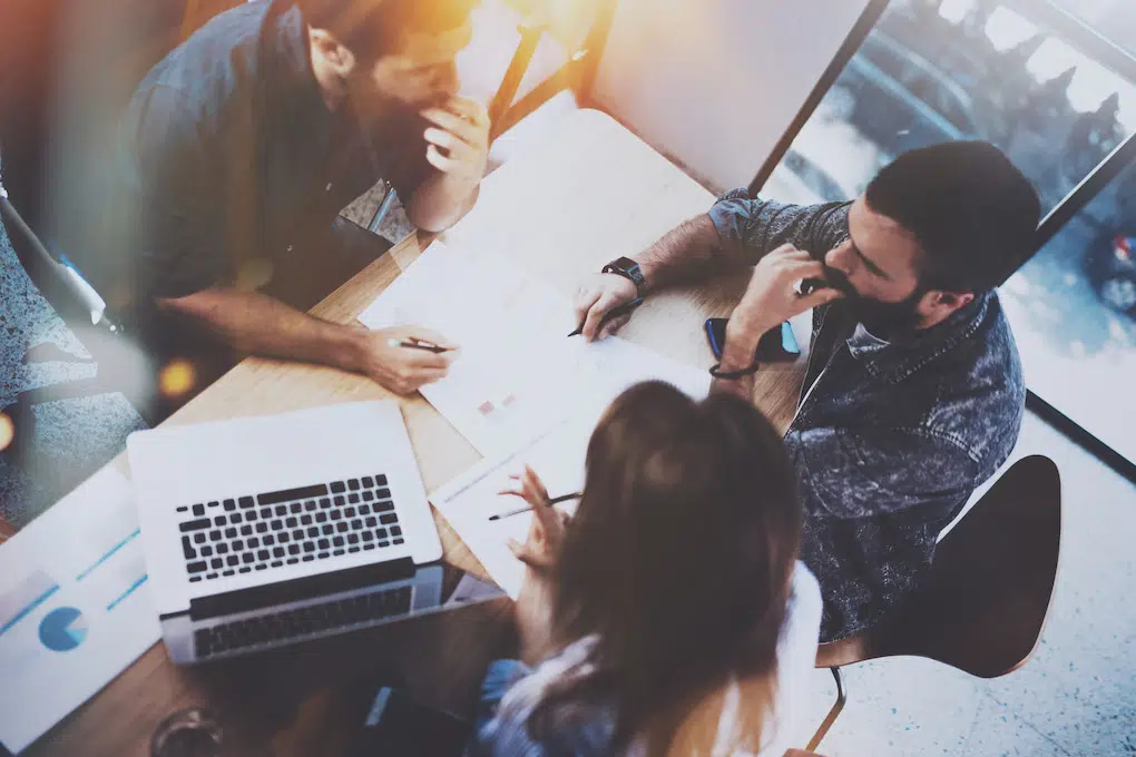 Engage directly with Detroit SEO strategies at our welcoming workspace. Our expert team collaborates around a wooden table, equipped with essential tools like detailed reports and advanced analytics on a laptop. Join us to harness cutting-edge SEO insights in a bright and inspiring environment.
