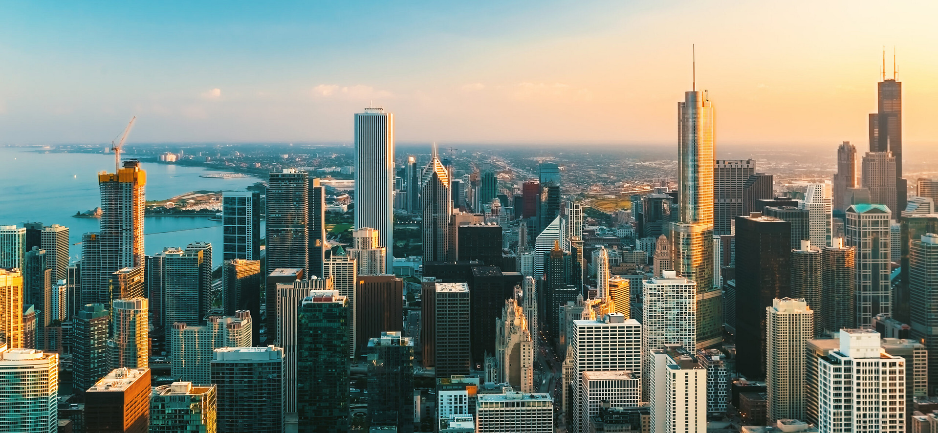 Capture the essence of Chicago's skyline at sunset with a clear view of its skyscrapers and Lake Michigan. The warm, golden glow sets an ideal backdrop for mastering PPC strategies from above.