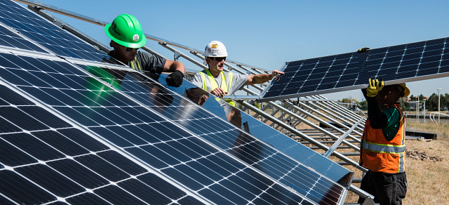 Men installing solar panels.