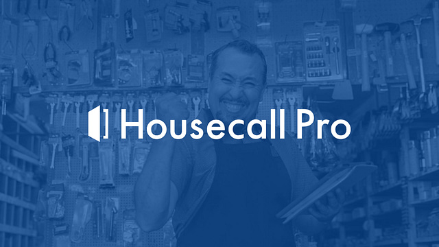 An individual in an apron is smiling while holding a tablet in a tool-filled hardware store. The prominent "Housecall Pro" text emphasizes how this HVAC CRM can efficiently streamline your business operations on Hook Agency's website.