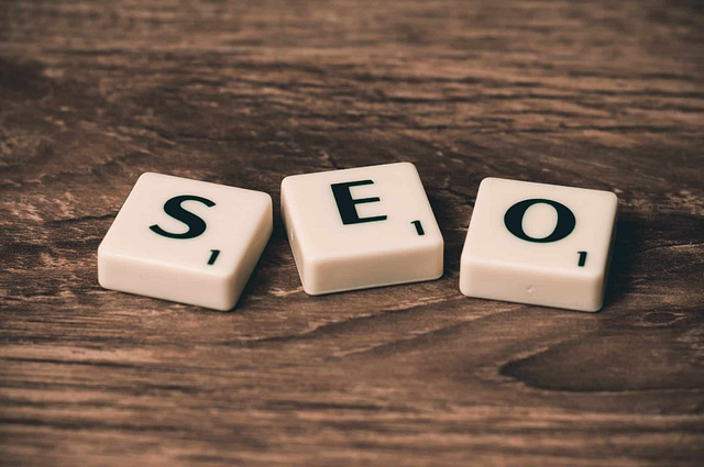 White Scrabble tiles on a wooden surface spell "SEO," each marked with a "1" point, symbolizing the importance of getting started in keeping up with the ever-evolving digital landscape.