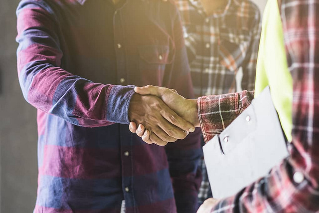 constructor shaking hands with hishome improvement leads