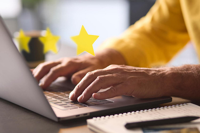 man using laptop to leave Google reviews