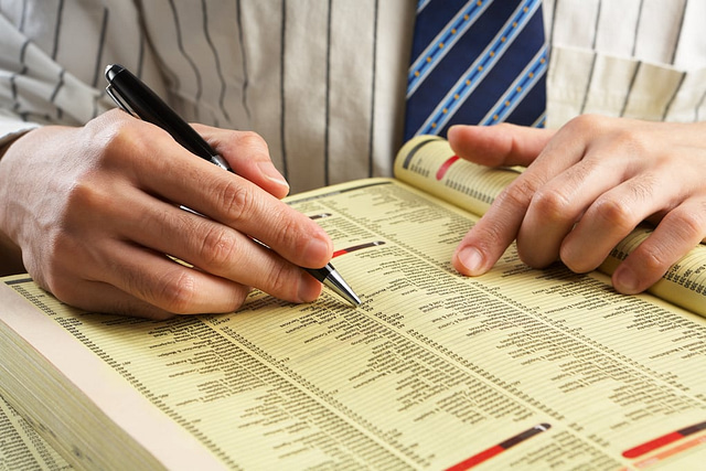 man searching through the yellow pages