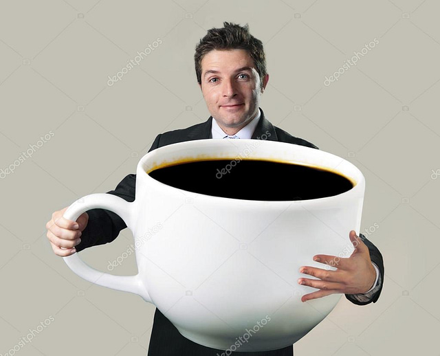 A man in a suit smiling while holding an oversized coffee cup filled with black coffee, this quirky stock photo fits perfectly for anyone searching through stock images or crafting clever memes against a plain backdrop.