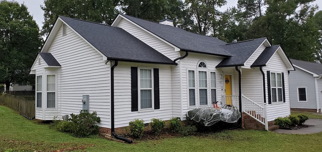 White single story house with a black roof