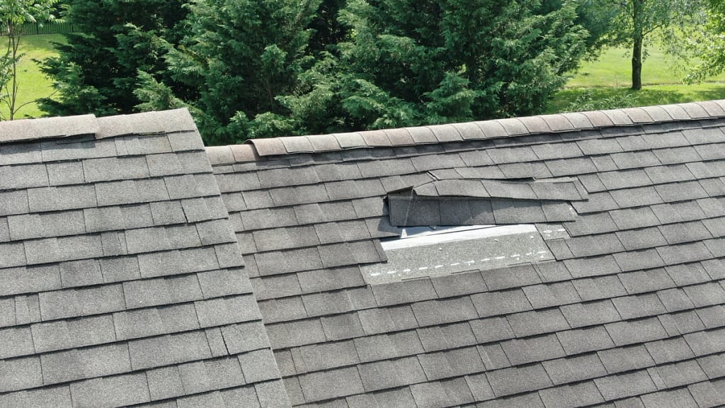 close up of hole in rooftop before scheduled roof replacement
