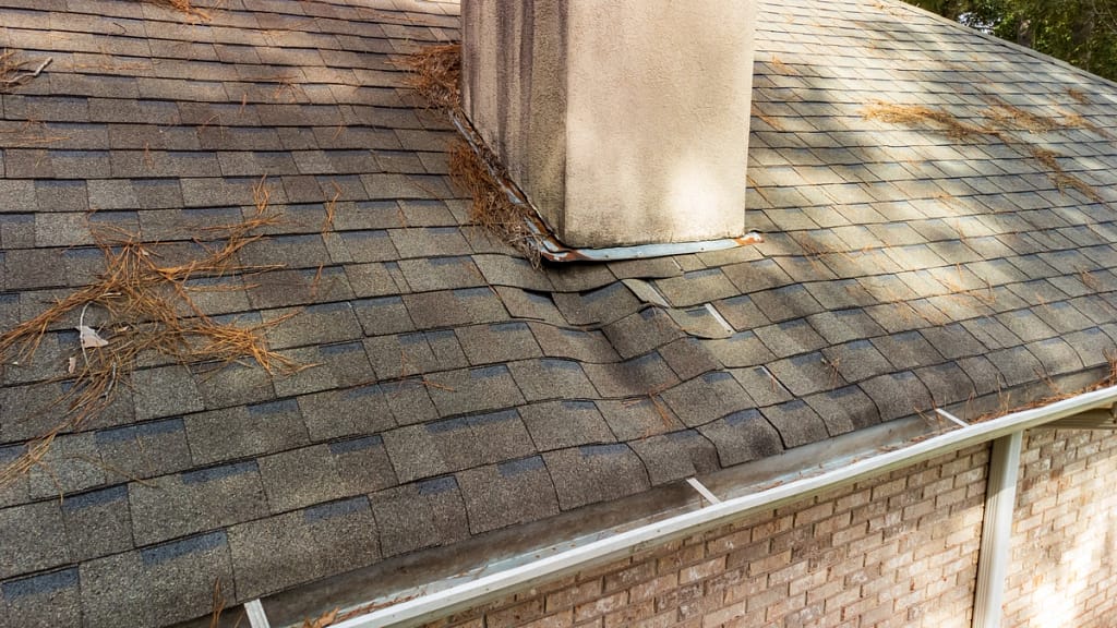 leaky asphalt roof begins sagging due to water damage