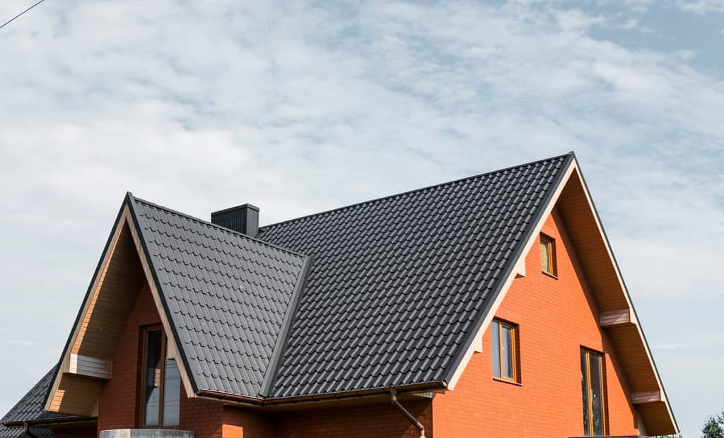 red brick wall house with metal roof