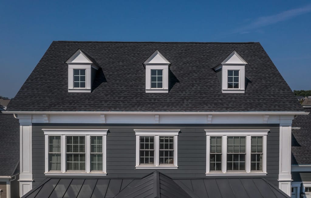 house roof with black shingles and dormers