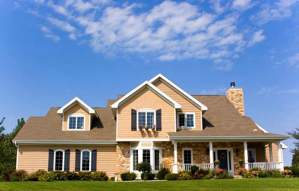 large home with shingle roof
