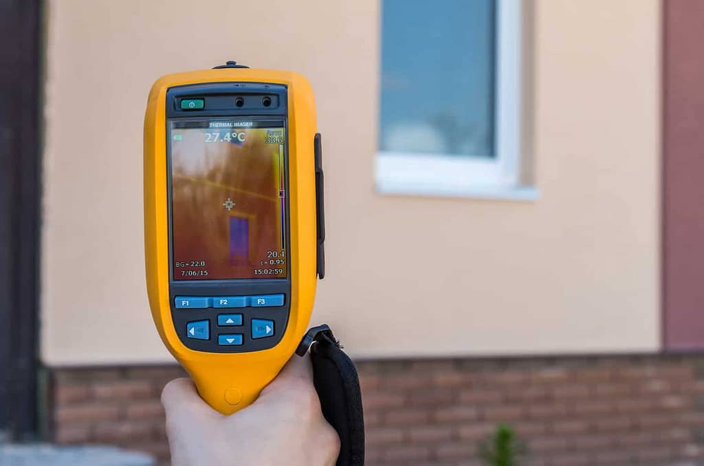 Infrared inspection of heat loss of window at house