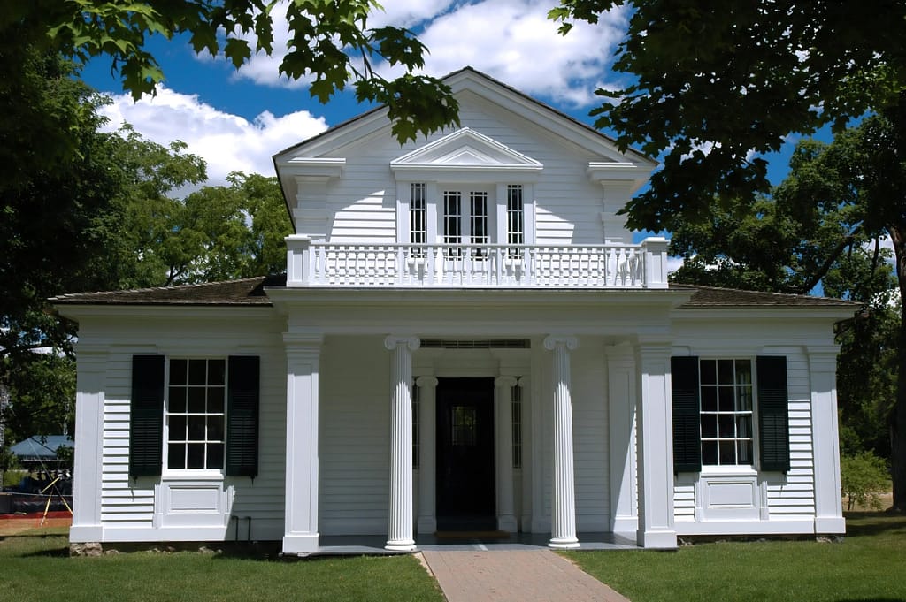 white home with a greek revival themed portico