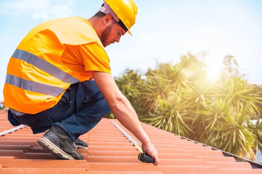 professional roofer measuring roof