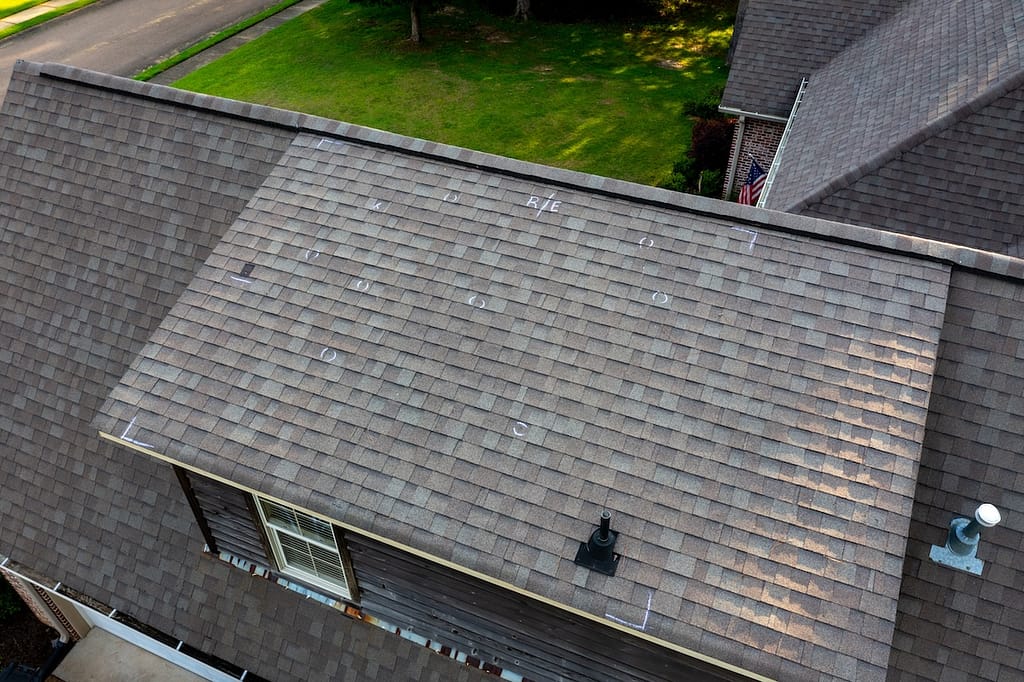 Roof with hail damage and markings from inspection