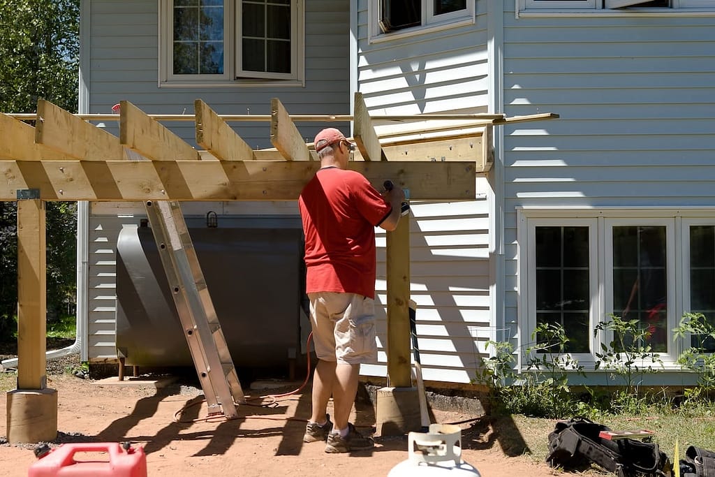Homeowner building a wooden frame for deck