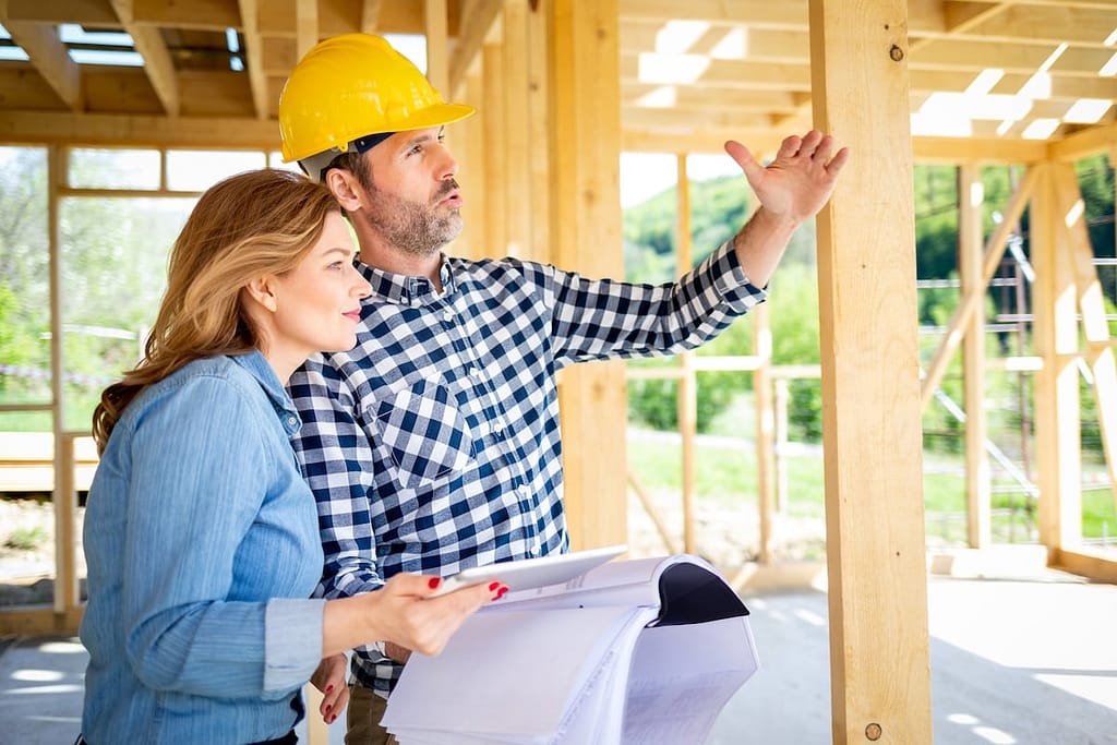 Contractor explains construction plans to homeowner