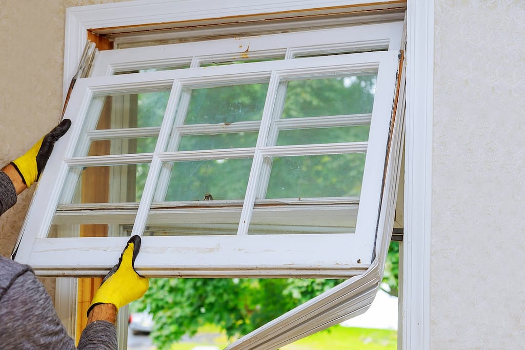person installing white windows