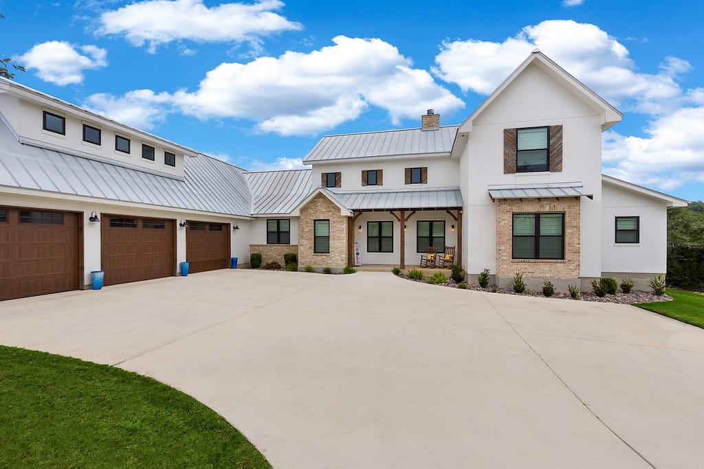 White farmhouse with large driveway