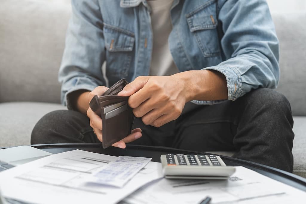 Debt financial concept, stressed problem people asian man, male hand open empty wallet not have budget of money to pay no have credit card, not able payment bill, loan or expense with bank, bankruptcy