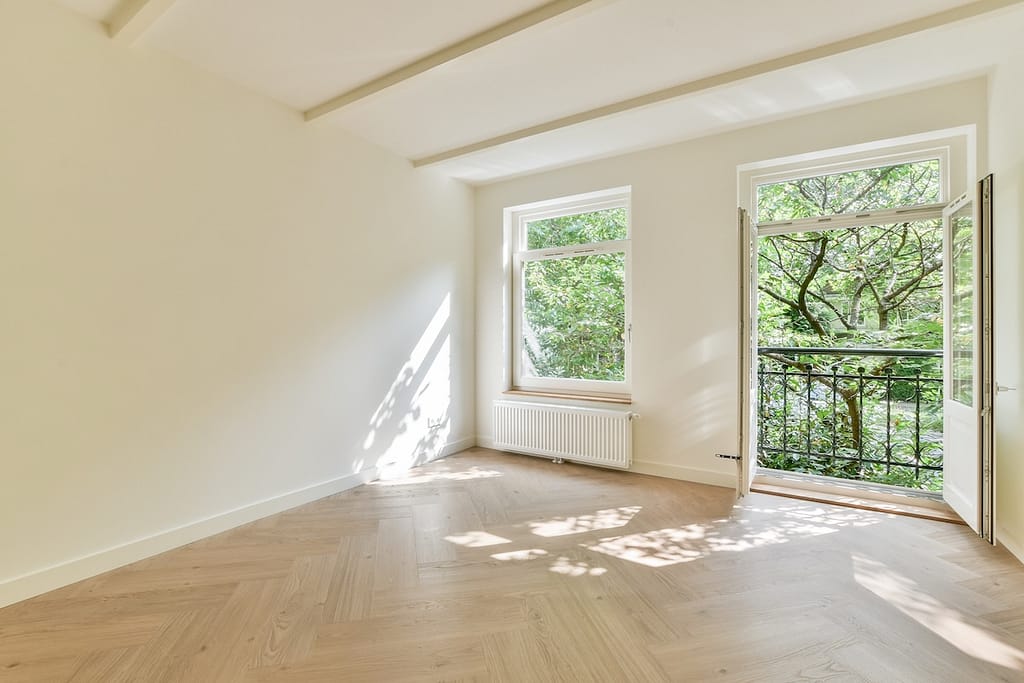This modern interior features large windows allowing natural light to flood the space, creating a serene and inviting atmosphere perfect for relaxation.