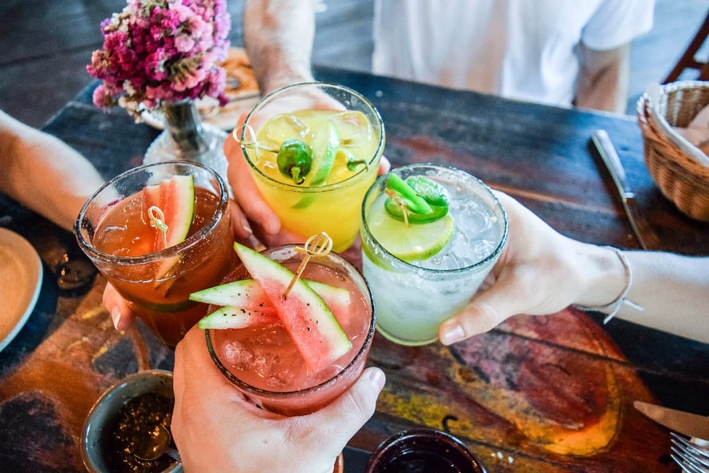 group of friends drinking cocktails at restaurant