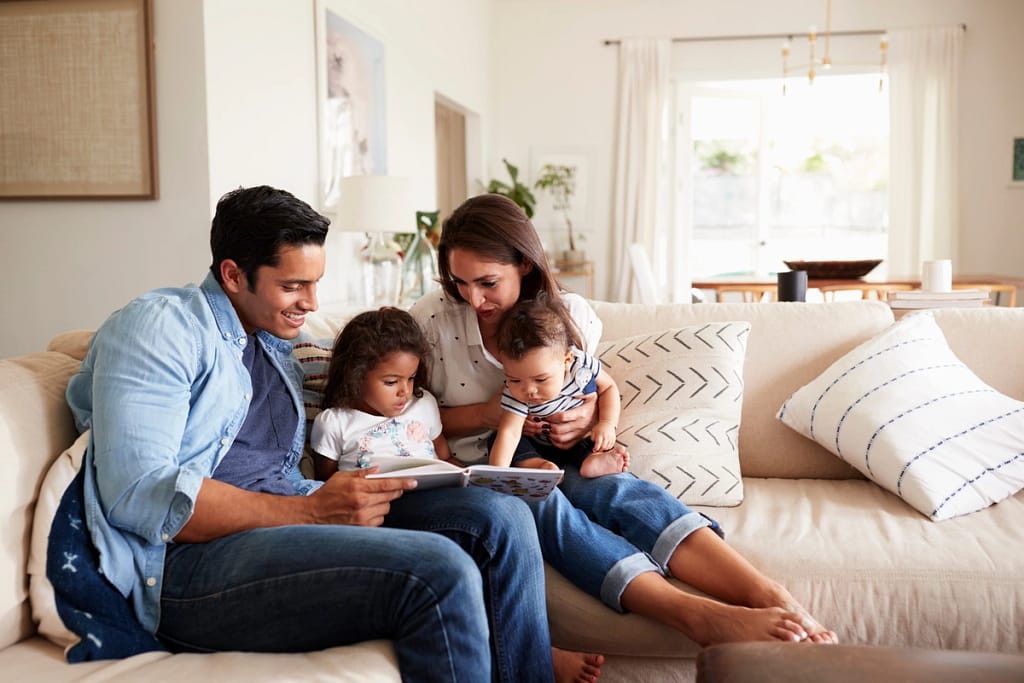 family of four sitting on couch