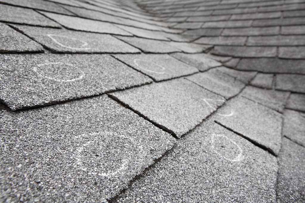 Old roof with hail damaged shingles