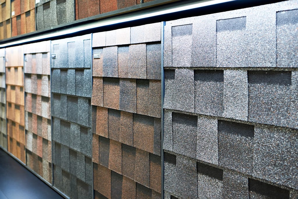 A wall of different colored shingle samples