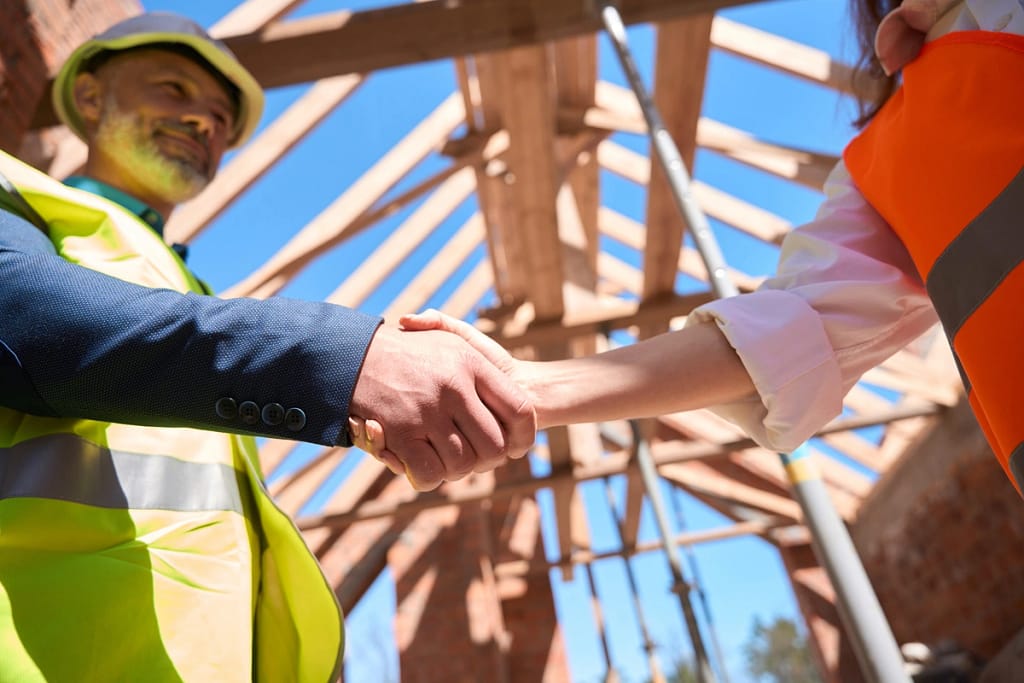 roofer shaking hands with a homeowner