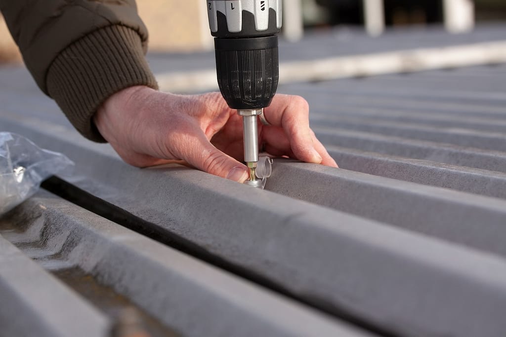 metal roof repair using a power drill and screws