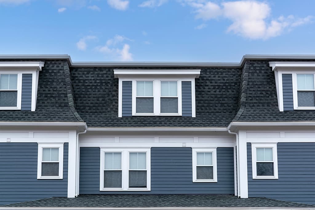 blue house with a black mansard roof