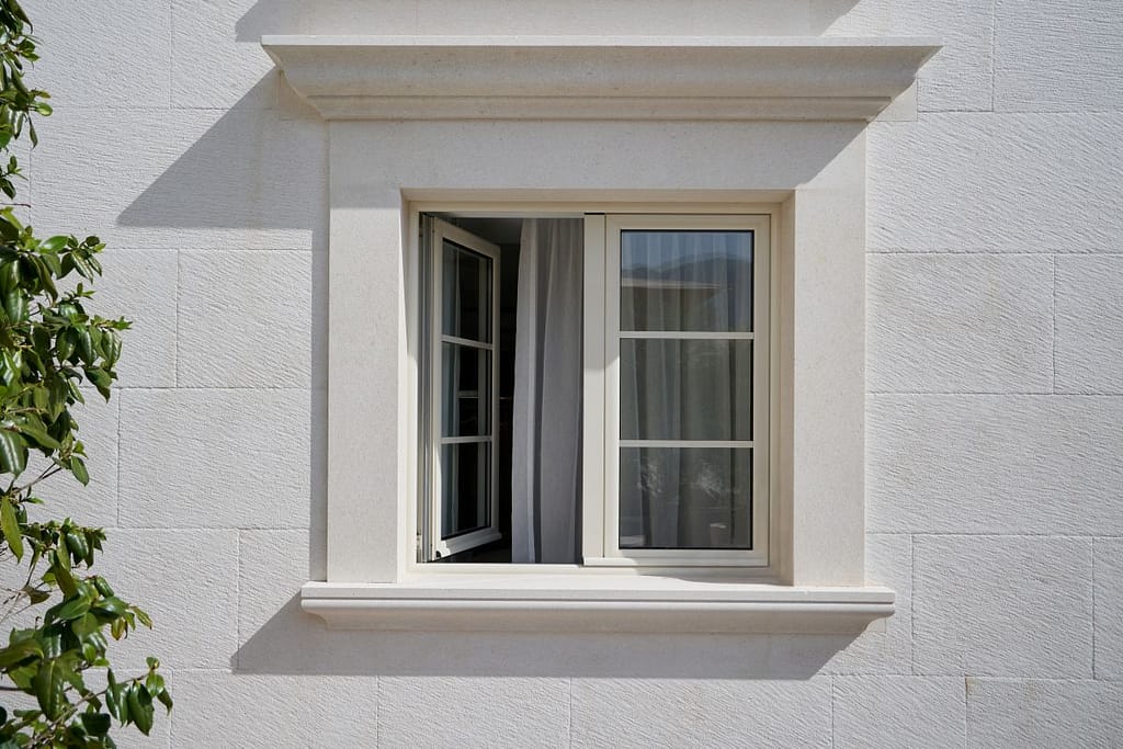 white house with a window that is half open