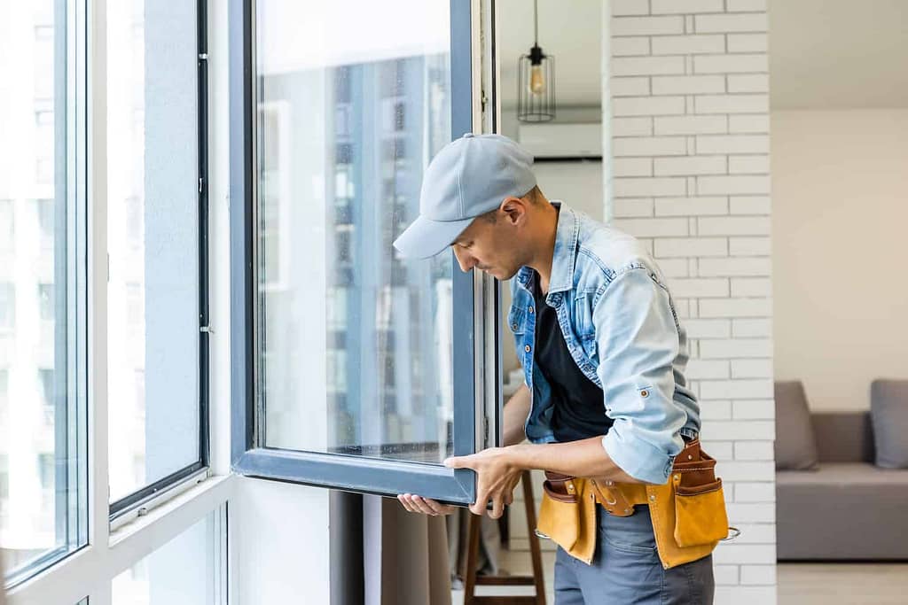 construction worker installing energy-efficient windows
