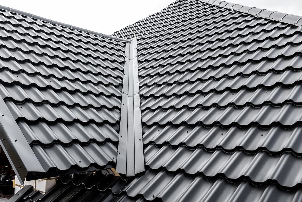 Construction of the roof of the house. Metal tiles.