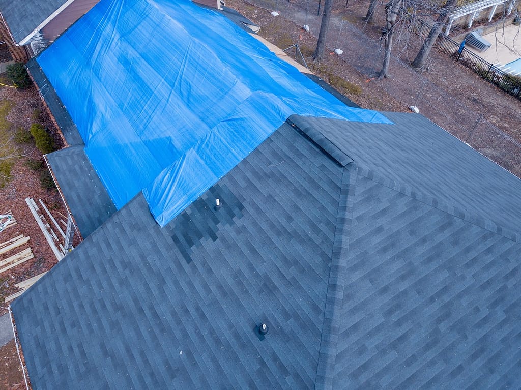 Fire damaged roof covered with tarp