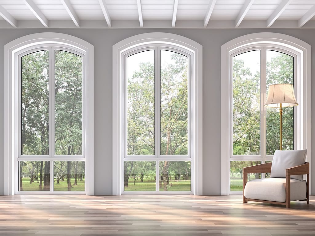 Modern classic living room with nature view 3d render.The Rooms have wooden floors and white wood ceilings.Decorated with white fabric chair,There are arch shape window sunlight shining into the room.