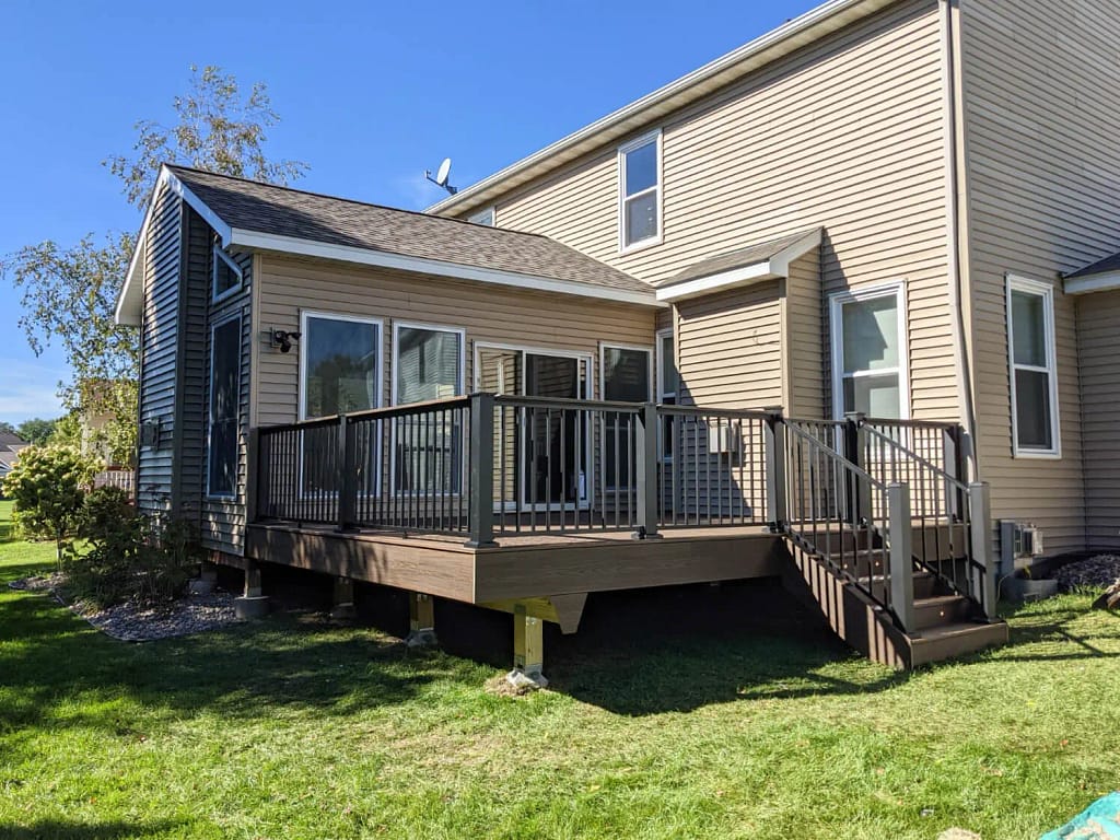 Spiced Rum colored Trex Deck with black Westbury railings. The deck has a gate, lights, and a drink rail.