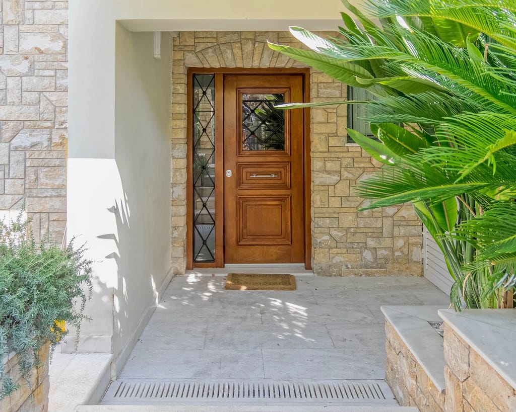Front door with a modern portico