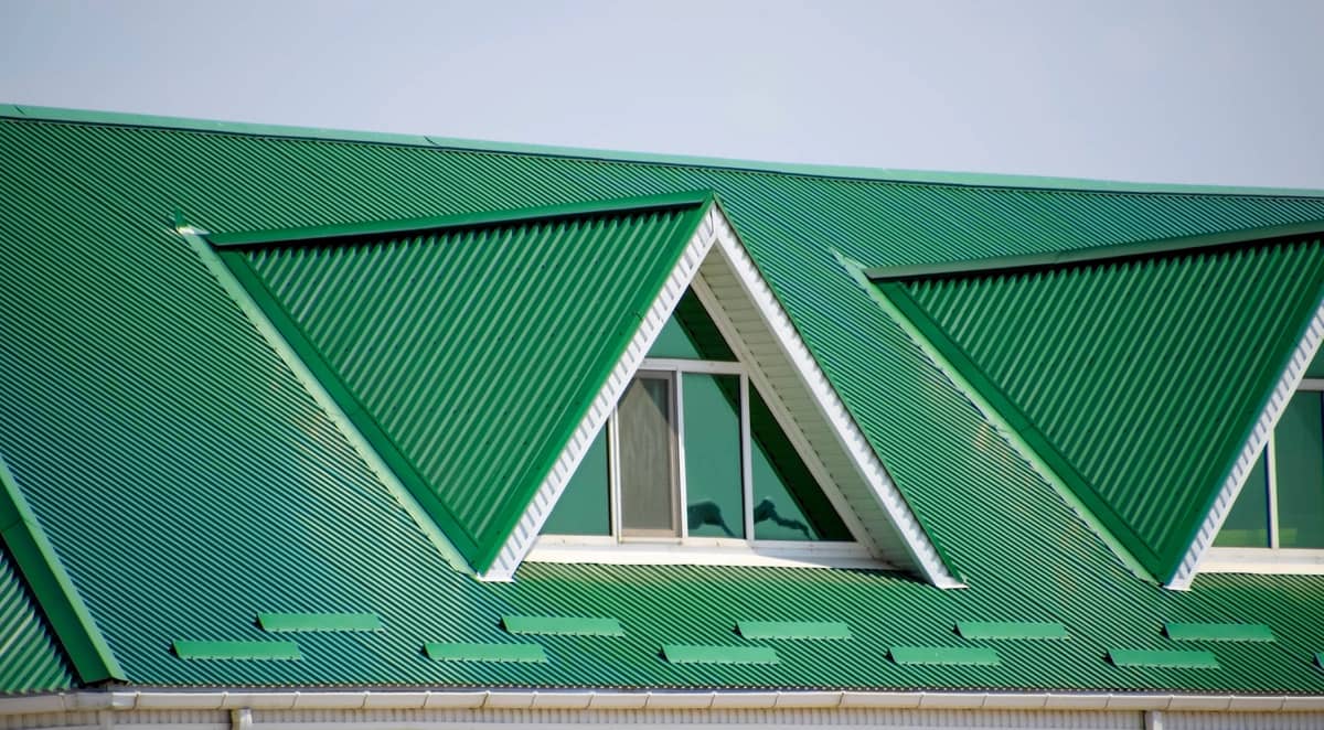 green corrugated metal roof with dormers