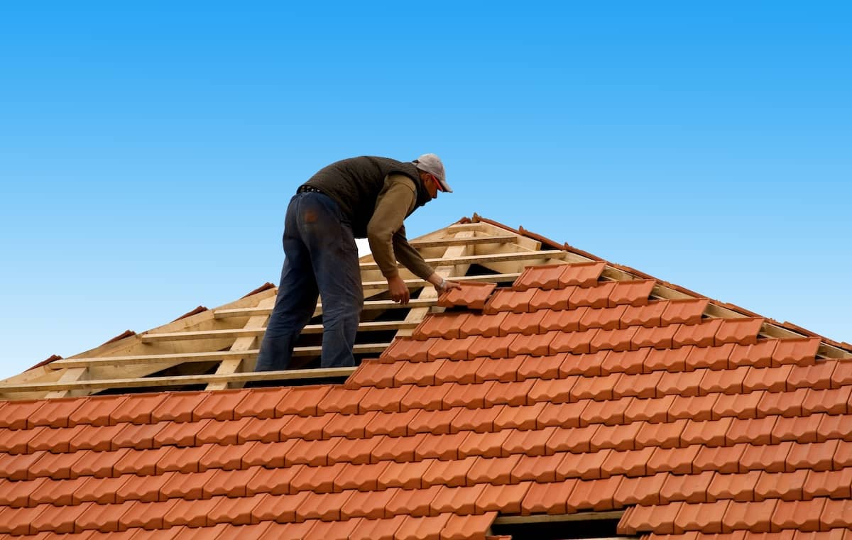 construction workers reapiring roof