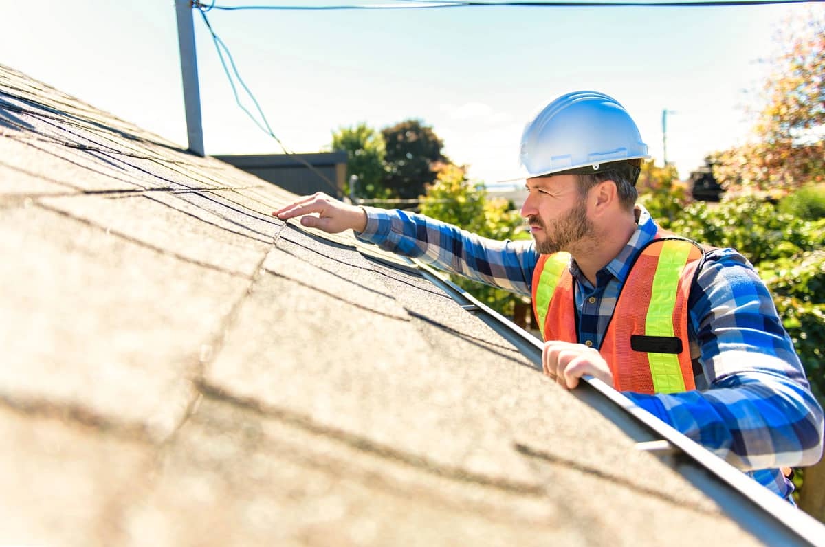 roofer performing a roof inspection