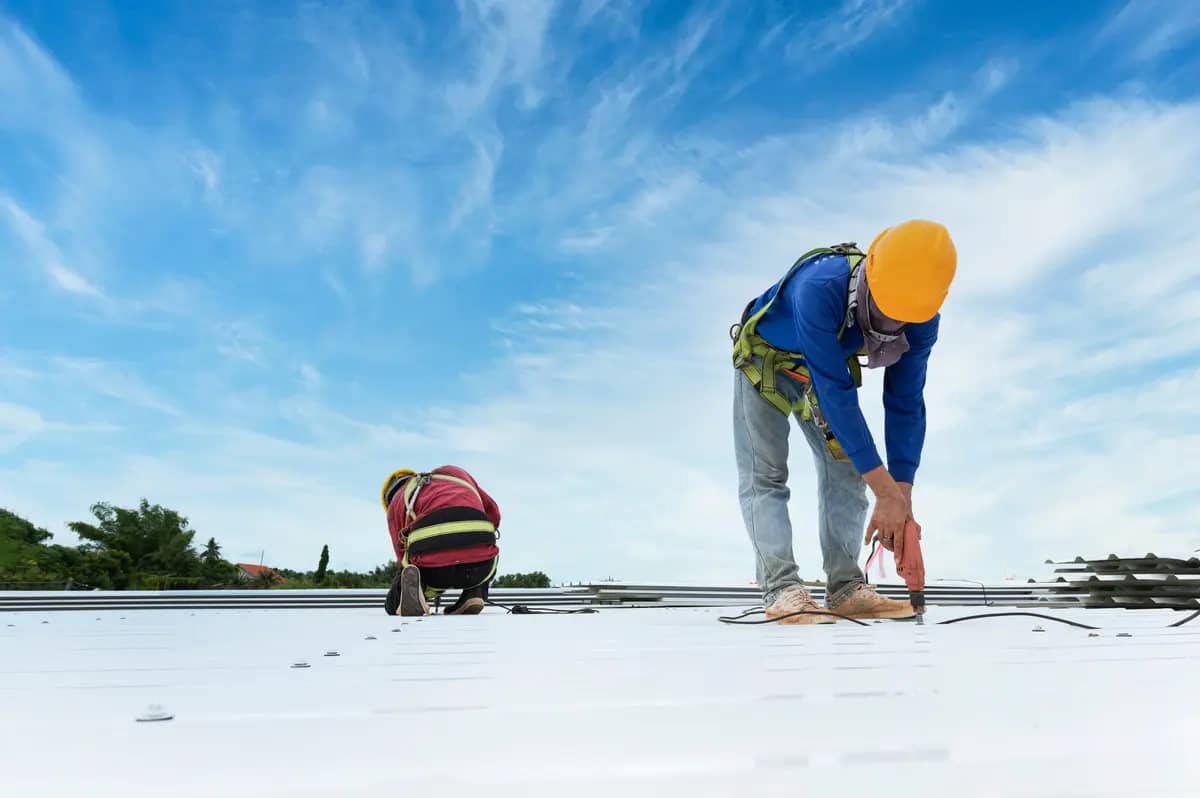 two guys maintaining a commercial roof