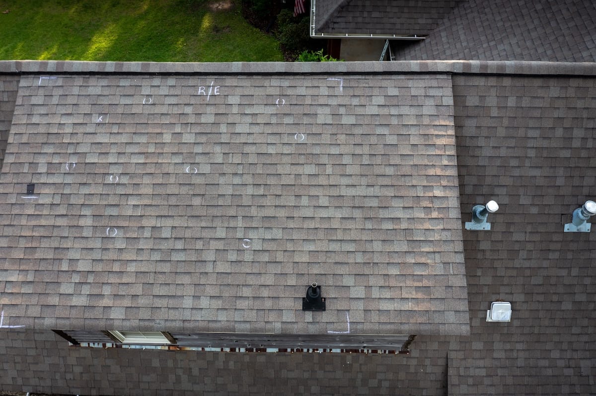 Roof with hail damage and chalk markings from inspection