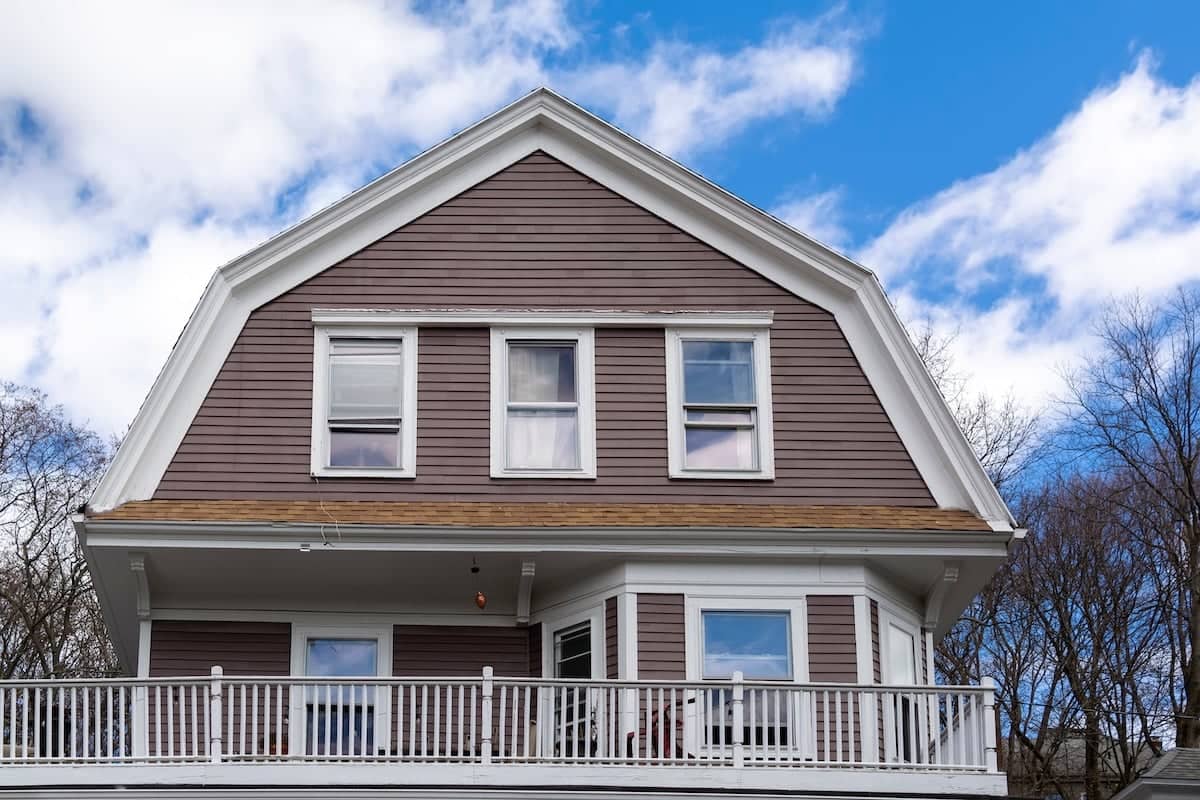 Tan house with white gambrel roofline